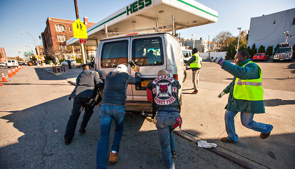 On Friday, the first day of gas rationing in New York City, a van without gas had to be pushed to a Hess station in Brooklyn.